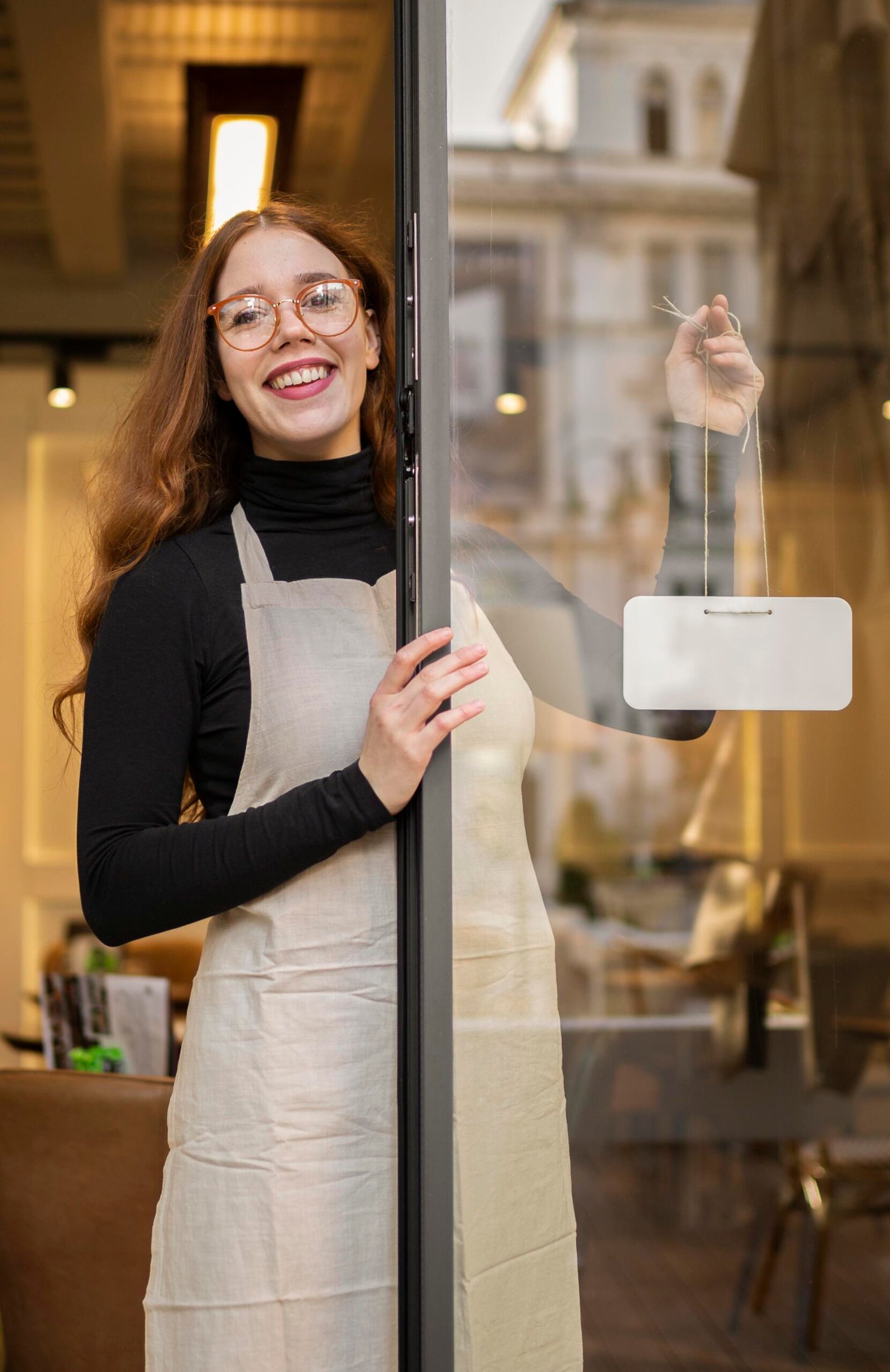 young-woman-holding-shop-sign